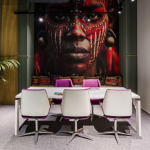Corporate boardroom with a woman mural and lounging area