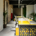 Corporate office space with a mural of a child and artificial greenery